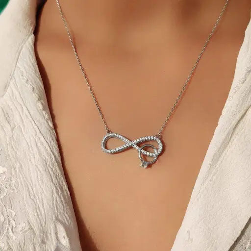 Silver ring in infinity pendant