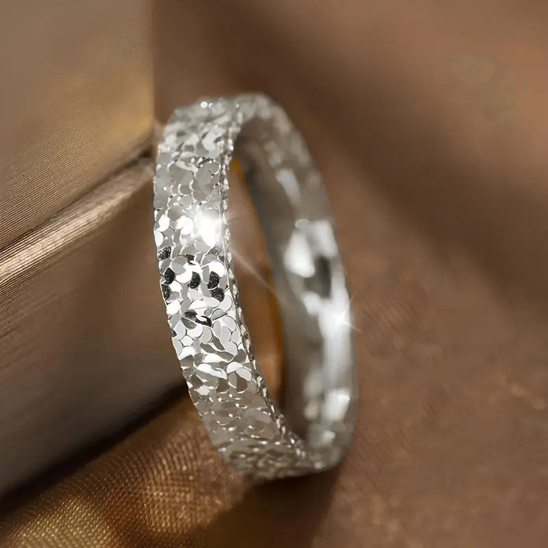 Silver uneven surface area ring