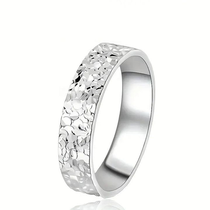 Silver uneven surface area ring