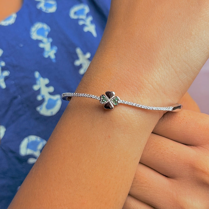 Silver flower with green and white stone kada