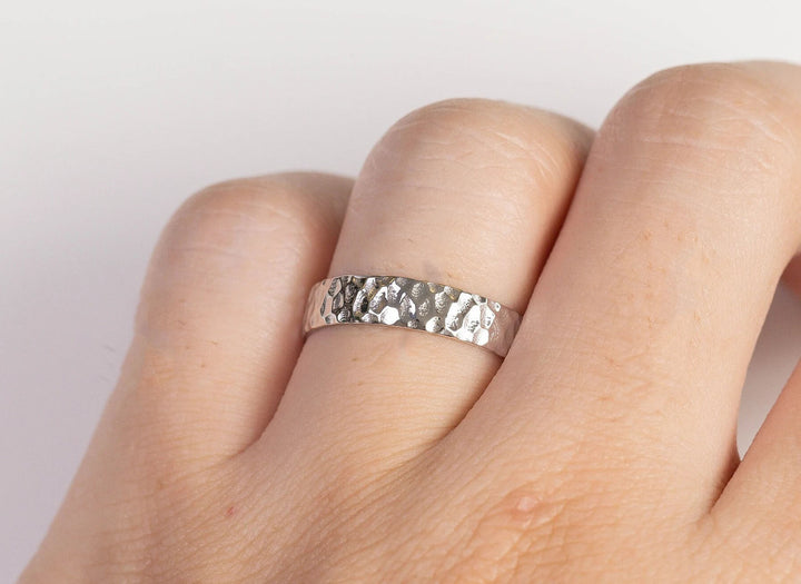 Silver uneven surface area ring